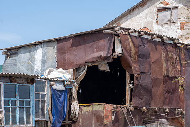 istock Dilapidated shack with patched walls and broken windows. 2218537117