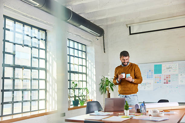 istock Happy creative man using cell phone at casual office. 2218537969