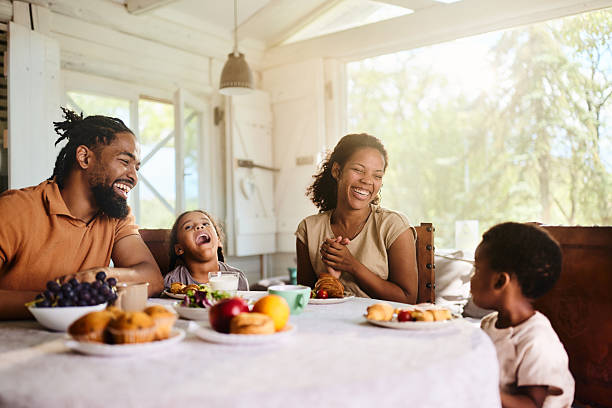 istock Cheerful black family talking during breakfast at dining table. 2218538112