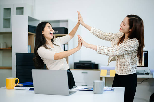 istock Two Asian businesswomen work together using laptops and documents planning project. and planning strategies together 2218538242
