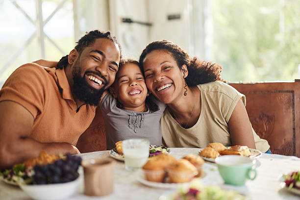 istock Happy black family enjoying during breakfast at dining table. 2218539794