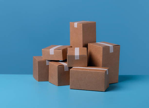 istock Stacked cardboard boxes against a blue background 2218539941