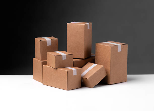 istock Stacked cardboard boxes against a dark background 2218539964