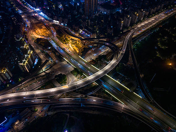istock Nighttime Urban Intersection with Illuminated Roads and Buildings 2218540103