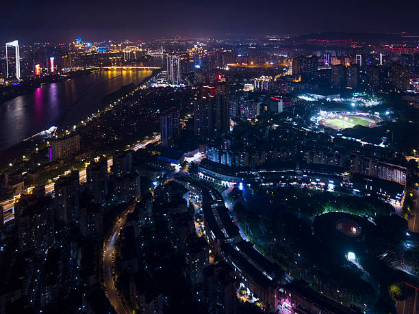 istock Nighttime Cityscape with Illuminated Buildings and Reflective Water 2218540126