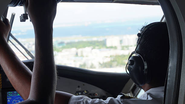 istock Pilot maneuvering aircraft during a landing approach over a tropical island 2218540240