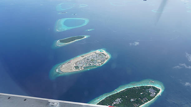 istock Airplane passenger window showing stunning maldives islands 2218540294