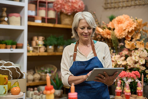 istock Florist managing inventory using digital tablet in flower shop 2218542779