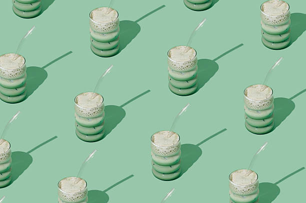 istock Creative summer pattern made of iced matcha latte on pastel green background. Minimal healthy matcha latte concept. Trendy drink idea. 2218543349