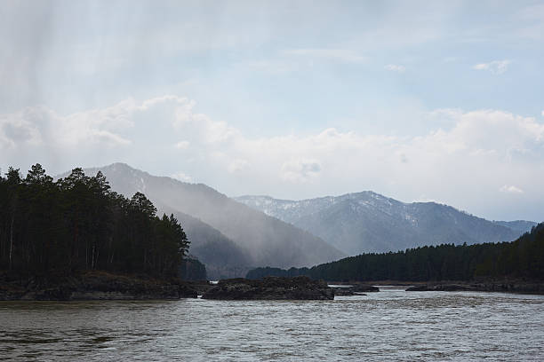 istock Scenic river view with mountains and mist under a cloudy sky in the wilderness 2218544894