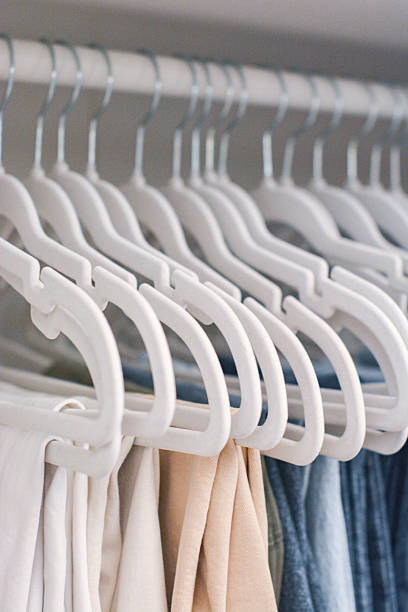 Velvet hangers with pants hanging sorted by color