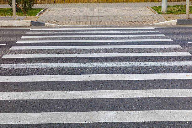 istock A crosswalk with a white stripe and black stripe 2218552171