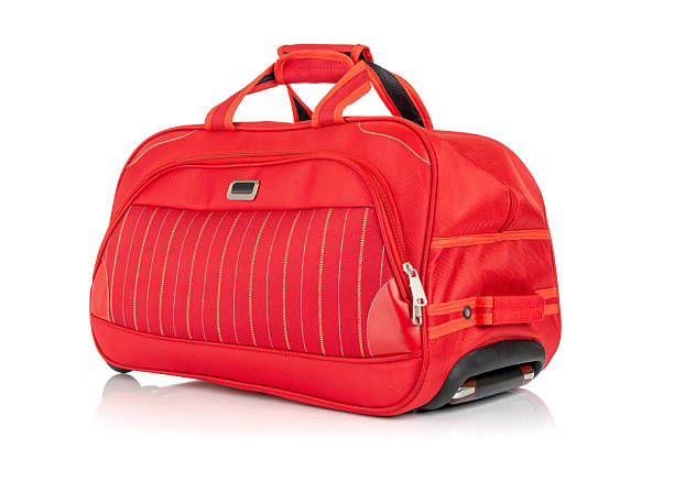 istock Bright red wheeled travel bag with side handles and front pocket. Studio shot isolated on white background. File contains a path to isolation. 2218552887