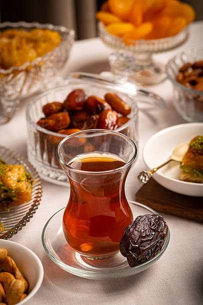 istock Traditional Turkish Tea with Dates and Oriental Sweets on Festive Table 2218553513