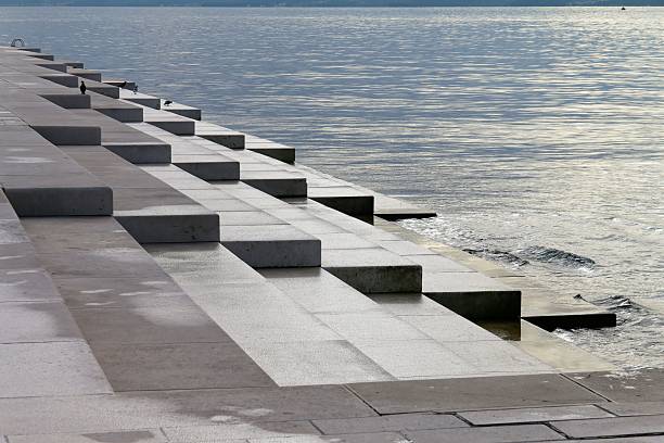 An old concrete staircase descends to the sea. An abandoned access to the water. A former public beach.