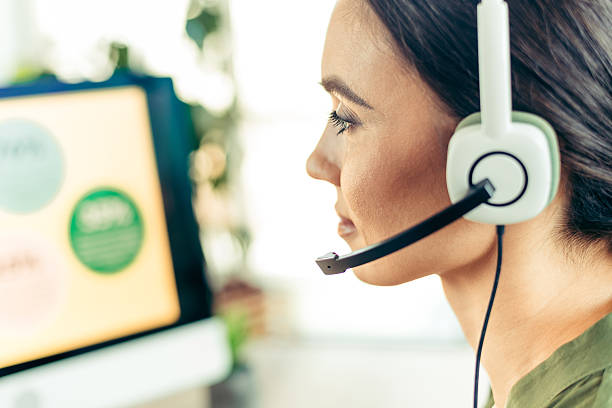istock Businesswoman working in an office using headphones while focused on her computer as part of a professional workspace 2218559555