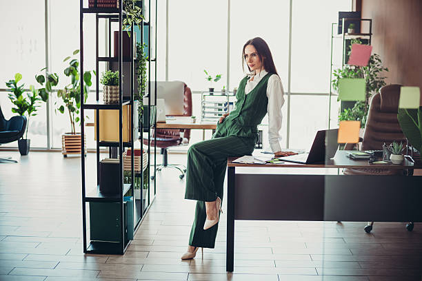 istock Hardworking professional woman in an office setting, showcasing confidence and style during a workday in a modern workspace 2218560113