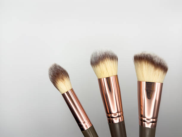 istock Makeup cosmetic brushes collection on white background with strong shadows background. Top view. Flat lay, knolling concept 2218563074