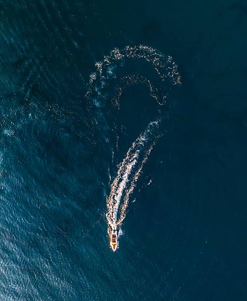 istock Boat's question mark trail on ocean. 2218563109