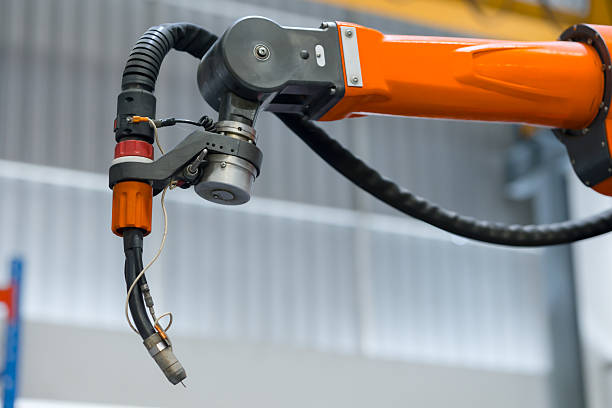 istock closeup welder head Robotic Smart Welding Machine. Welder arm machine, Robotic Welding or Robotic Arm Welding at Industrial Factory. 2218566222