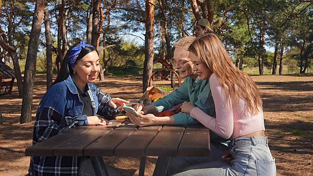 istock Friends Enjoying a Picnic and Having Fun Outdoors Together 2218567564