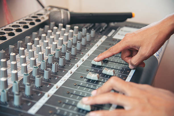 istock Production sound engineer woman hands adjusting volume equalizer voice, mixing console. DJ sound engineering working on recording studio mixing voice control.  Producer remix tune music sound record 2218567864