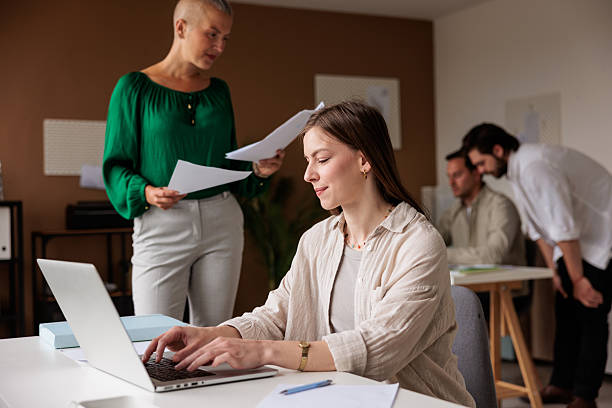 istock A young woman working at the busy office 2218574146