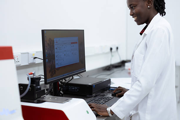 istock Scientist, woman and microscope with computer for laboratory research, test and DNA investigation at night. Professional doctor or science expert with lens check, laptop and particles for inspection 2218574640