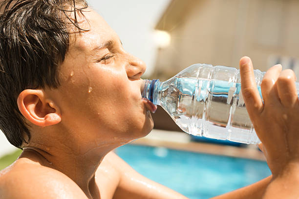 istock young man drinking water from a bottle in summer 2218575528