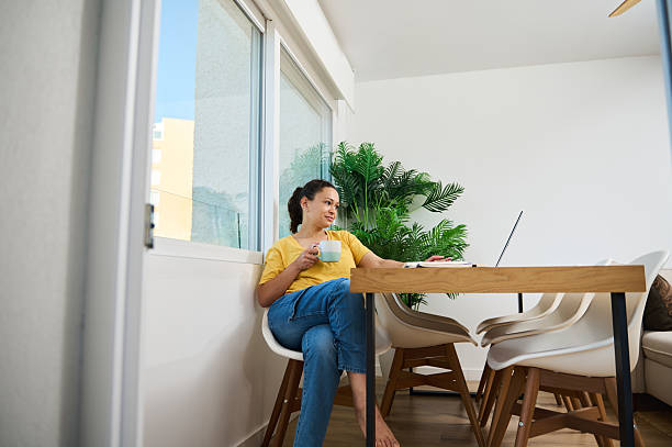 istock Woman Relaxing With Coffee at Home While Working on Laptop 2218578809