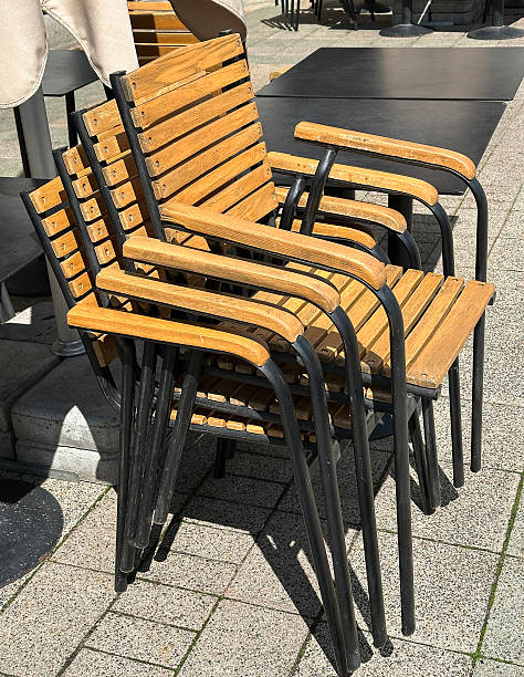 istock Wooden chairs stack on the street 2218580022
