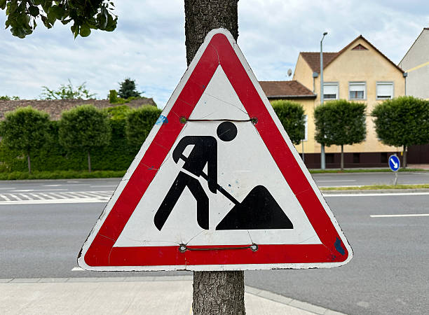 istock Road works traffic sign on a tree trunk 2218580053
