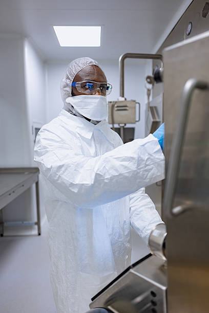 istock Close up portrait of engineer wearing protective workwear touching a screen in a lab 2218581484