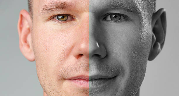 Split-toned portrait of a man showcasing contrasting facial features in a studio setting