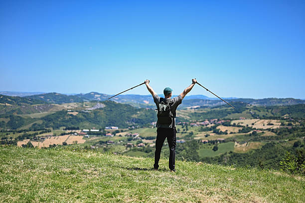 Pilgrim with arms open on the french Way of St James (Camino de Santiago) to Compostela, near Astorga, Leon, Spain