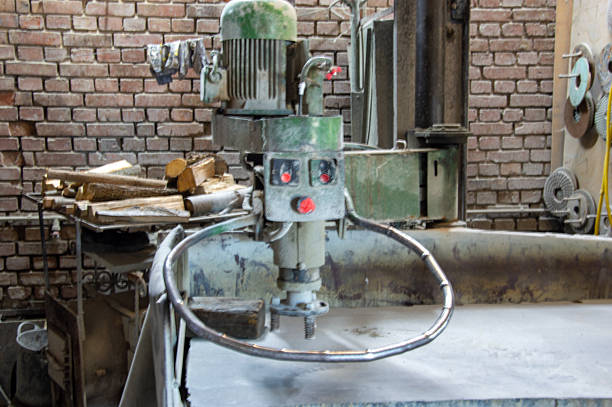 istock A large mixing machine sits on a workbench, surrounded by tools and wooden logs in a well-lit workshop filled with brick walls 2218582372