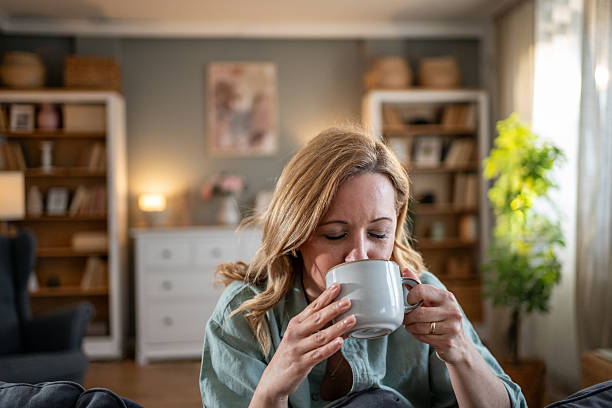istock Serene woman enjoying a hot beverage at home 2218583048