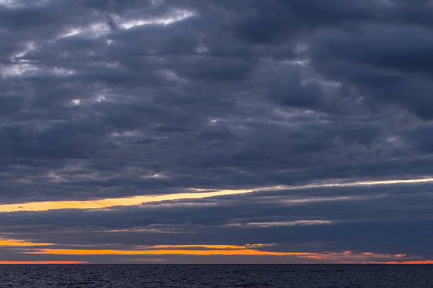 istock Coastal landscape photo featuring dark cloudy sky over the horizon 2218583576