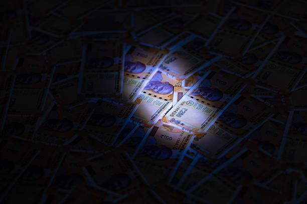Close-up of stacked Indian rupee 100 notes isolated on white background, symbolizing small denomination cash, savings, daily expenses, and Indian financial system.