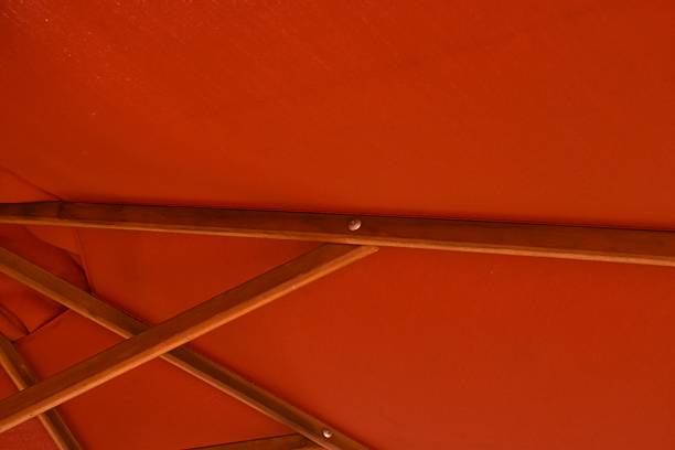 istock red umbrella fabric with long wooden handle background and texture 2218589291