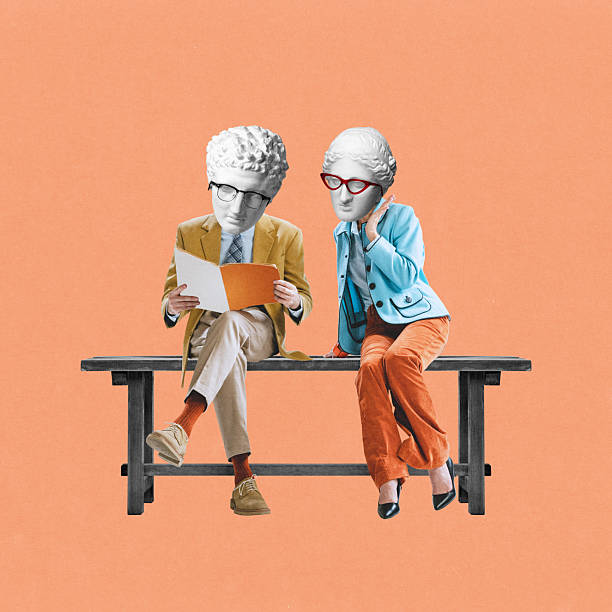 Creative artwork. Two statue-headed characters in vintage outfits sit on bench reading and chatting with serious expressions against coral background.