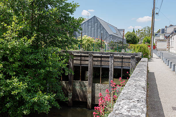 Canal Boat passing through a Lock with Lock Keepers house.
