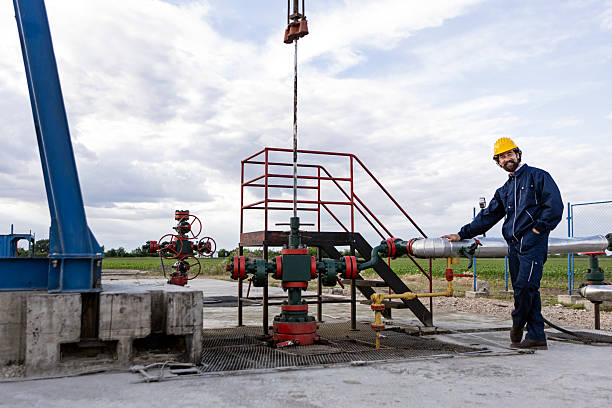 Oil industry worker working in an oil field. About 40 years old, Caucasian male.
