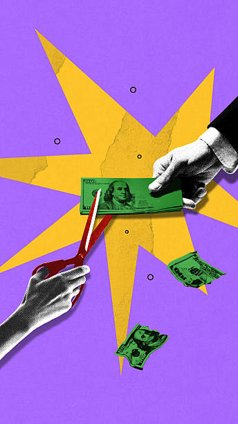 istock Hand with scissors slices dollar stack in businessman's hand. Cutting Value. Conceptual collage. 2218594849