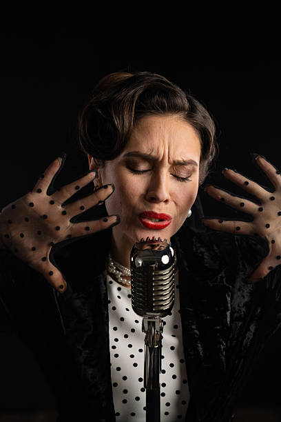 istock Vintage Style Singer Performing with Retro Microphone 2218594921
