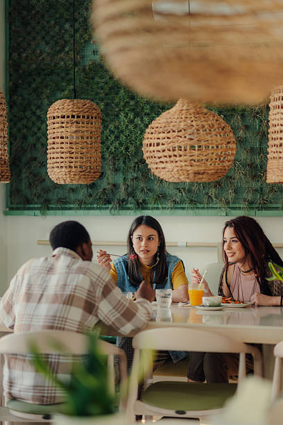 istock Young friends having lunch together in a modern restaurant 2218596327