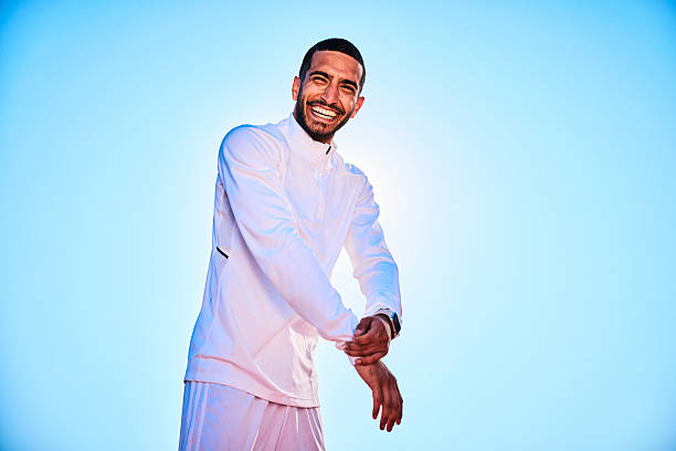 istock Young man adjusting white spots top and smiling towards camera 2218596401