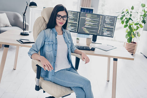 istock Portrait of attractive skilled girl top web expert leader developing project start-up sitting in chair at workplace workstation indoors 2218599850