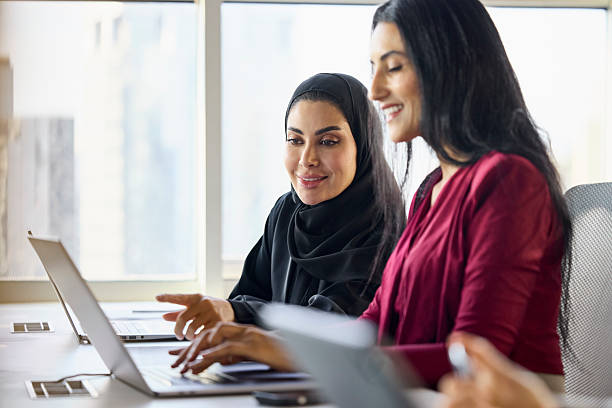 istock Smiling Emirati professional assisting colleague 2218600305