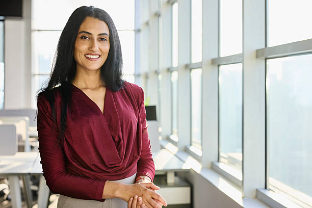 istock Smiling businesswoman standing with hands clasped 2218600356